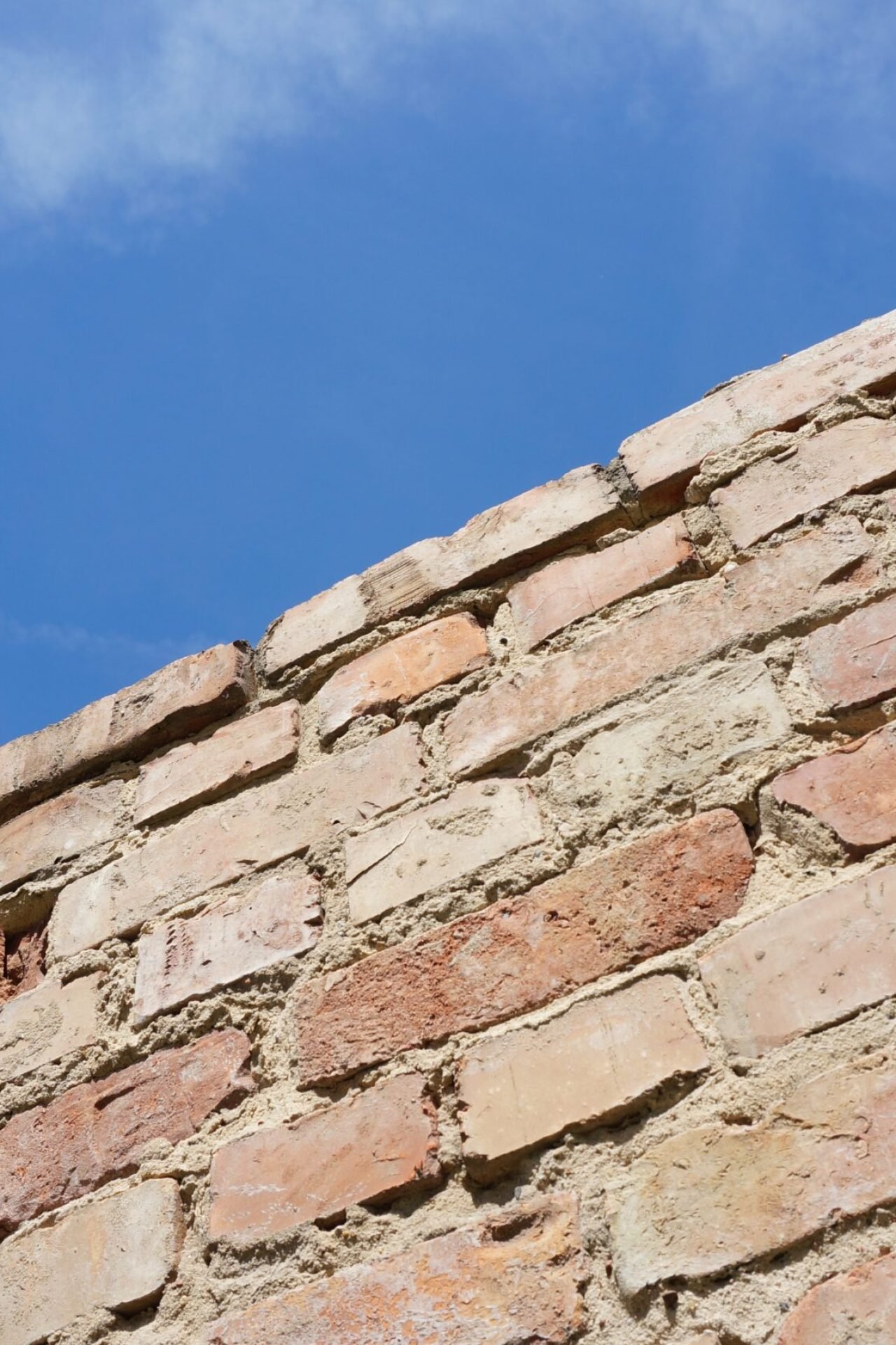 A low angle shot of an old brick wall