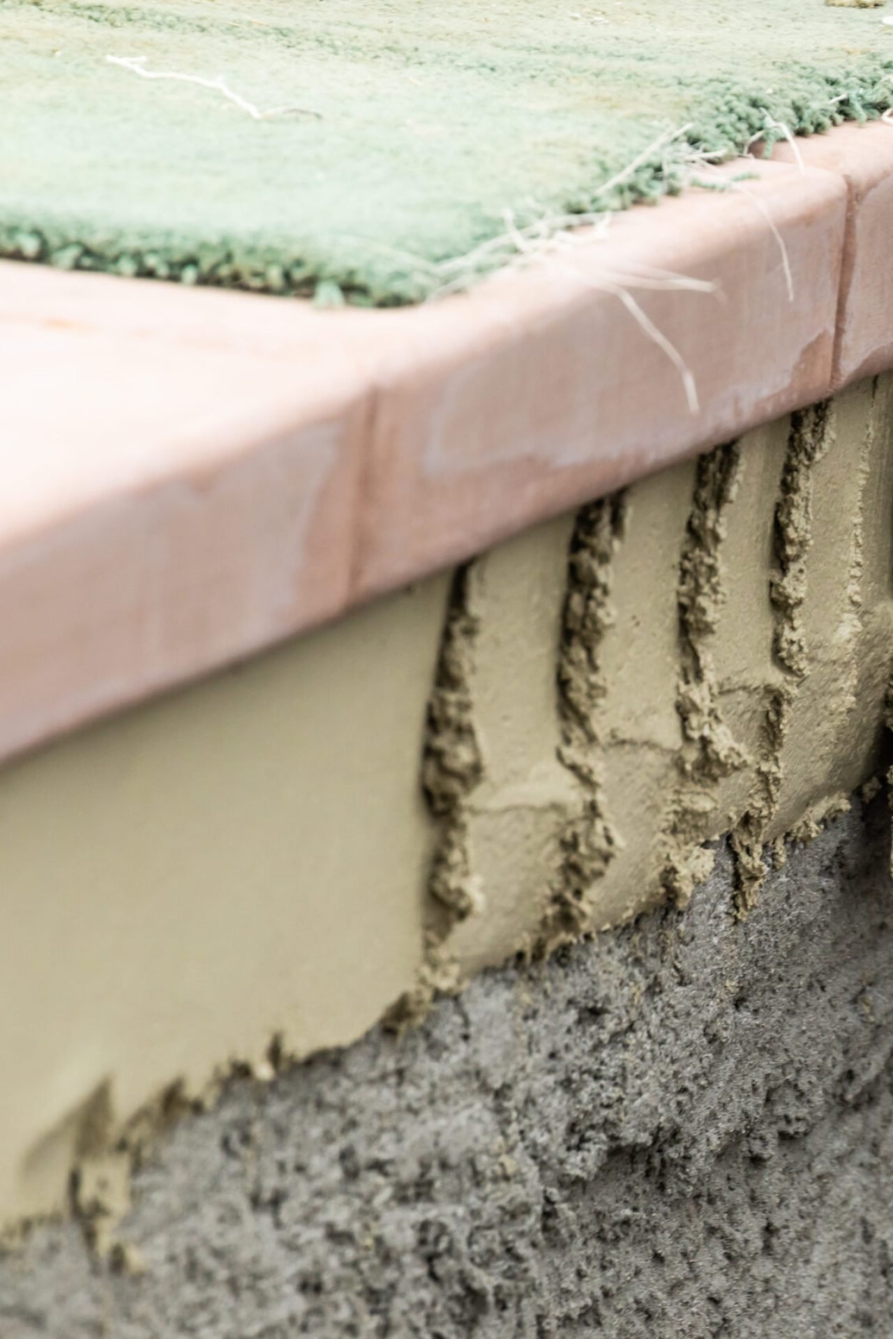 Tile Worker Applying Cement with Trowel at Pool Construction Site. Tile Worker Applying Cement with Trowel at Pool Construction Site.